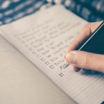 Grocery List - person writing bucket list on book