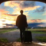 Sustainable Travel - man holding luggage photo