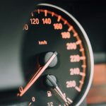 Electric Hybrid Car - closeup photo of black analog speedometer