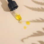 Skincare Products - a dropper bottle filled with yellow liquid sitting on top of a table