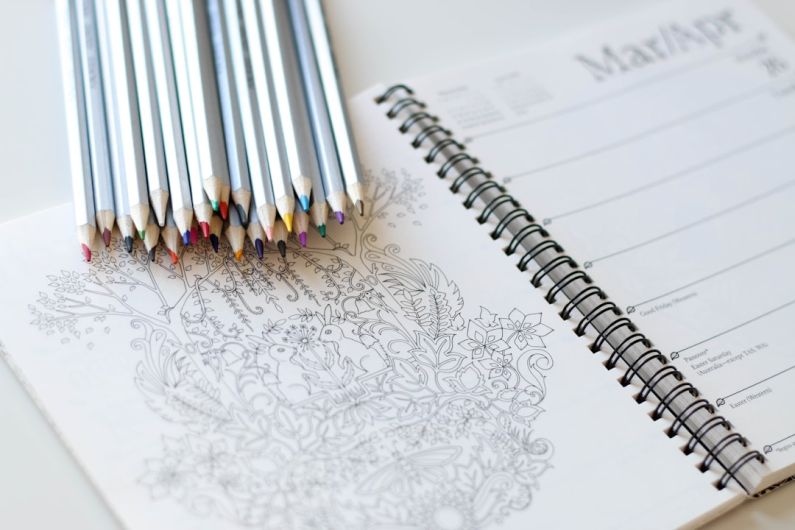 Coloring Book - coloring pencils on notebook